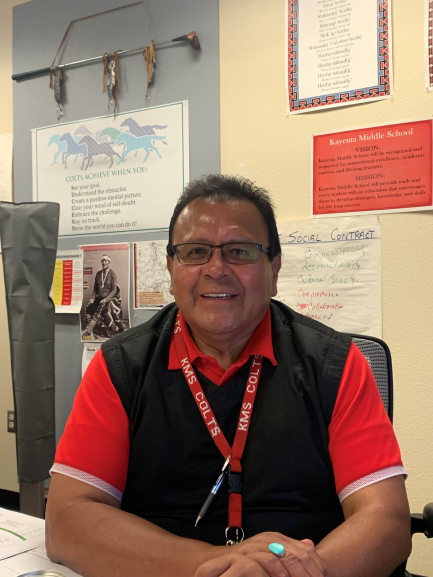 Principal sitting at desk